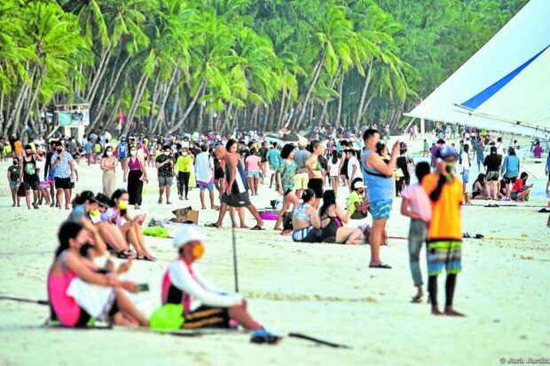 Tourists on a Boracay beach STORY: Boracay logs over 1 million arrivals in first half of 2023