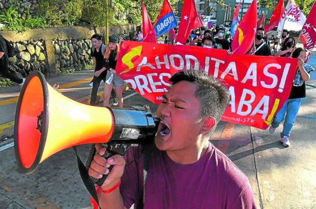 IN PHOTO: Activist with mic. STORY: Red-tagged activists seek SC protection.