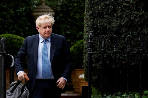 FILE PHOTO: British PM Johnson walks outside his home, in London