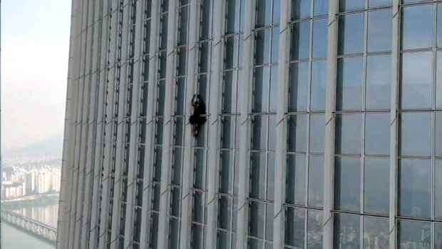 A British man climbs South Korea’s tallest building, the 123-storey Lotte World Tower, without a rope before being forced to abandon the climb more than halfway up, in Seoul, South Korea, June 12, 2023. South Korea’s Songpa Fire Station/Handout via REUTERS