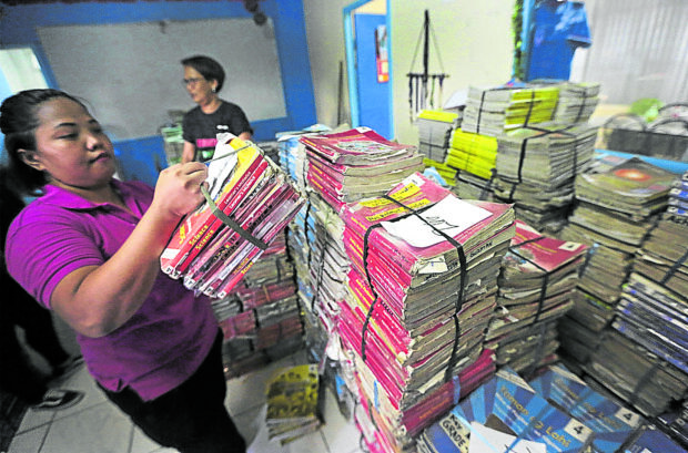 Teachers arrange books set out for condemnation which will be replace with newer editions at Pinyahan Elementary School in Quezon City on Wednesday, May 22, 2019 a few weeks before the start of classes. STORY: Revisions delay procurement of school textbooks