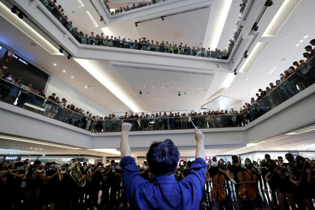 FILE PHOTO: A group of music performers plays a protest song "Glory to Hong Kong" during an anti-extradition bill protest in flash mob inside a shopping mall at Kowloon Tong, in Hong Kong