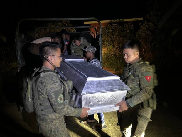 Soldiers deliver the body of a slain New People’s Army (NPA) combatant Jayman Taata alias Rico to his family in Dilud village in Dumingag town, Zamboanga del Sur at dawn Sunday. Taata was killed in a clash with government troops. PHOTO BY 53rd IB