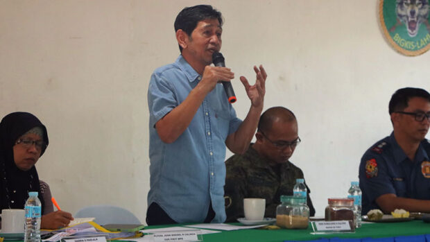 Mayor Sumulong Sultan (standing) convened the municipal peace and order council to address resurgence of violence and gun attacks in town. Lt. Colonel Rowel Gavilanes, 90th Infantry Battalion commander, stresses a point during the MPOC meeting, urging village officials to take part in peace building. (90th Infantry Battalion photos)