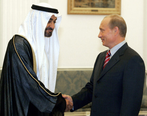 FILE PHOTO: Russian President Putin shakes hands with Sheikh Mohammed bin Zayed al-Nahayan during their meeting in Moscow