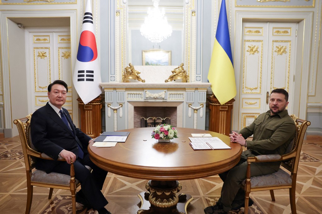 This handout photo taken on July 15, 2023 and released by the South Korean Presidential Office via Yonhap shows South Korean President Yoon Suk Yeol (L) posing for photos with Ukrainian President Volodymyr Zelensky (R) during their meeting at the presidential palace in the Ukrainian capital Kyiv. South Korea's President Yoon Suk Yeol was in Ukraine on July 15, on an unannounced visit, his office said, where he visited the town of Bucha ahead of a summit with Ukrainian leader Volodymyr Zelensky. (Photo by Handout / South Korean Presidential Office / AFP)