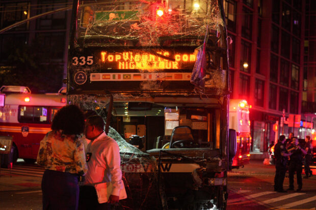 Eighteen people were taken to hospitals after a double-decker tour bus collided with a New York City commuter bus