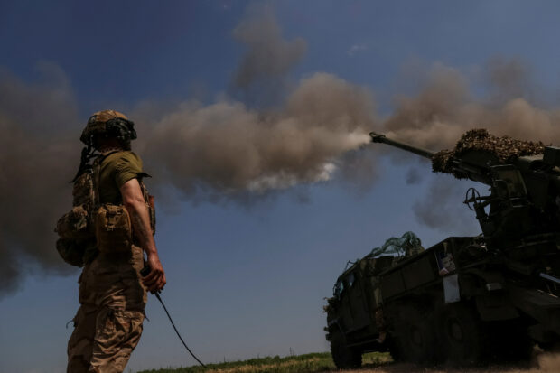 A Ukrainian serviceman of the 57th Kost Hordiienko Separate Motorised Infantry Brigade fires a 2S22 Bohdana self-propelled howitzer towards Russian troops, amid Russia's attack on Ukraine, at a position near the city of Bakhmut in Donetsk region, Ukraine July 5, 2023. REUTERS/Sofiia Gatilova/File Photo