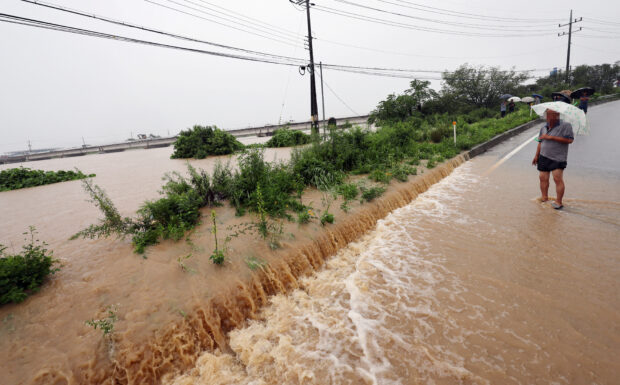 A view of a road submerged by a flooded river caused by heavy rain in Cheongju, South Korea, July 15, 2023. 