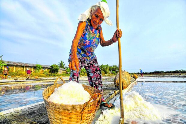 AGE-DEFYING LABOR Marcela Cereza, 86, is the oldest salt farmworker in Dasol that produces 18,000 metric tons of rock salt a year. Key industry players lament that local salt production has been neglected by the government.