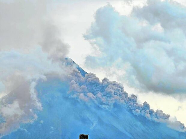 STILL RUMBLING Mayon Volcano continuously generates pyroclastic density currents and lava flow as seen in this photo taken at 5:40 p.m. on Monday in Daraga, Albay. The Philippine Institute of Volcanology and Seismology has recorded increased activity on Monday morning due to lava dome collapse. —PHOTO CONTRIBUTED BY DENNIS MIRABUENO