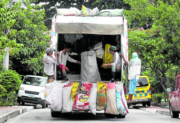 COSTLY HAULERS With still only a minority of Filipino households engaging in composting, recycling and segregation of garbage—and with the use of plastic packaging still the norm— trash collection remains a mammoth, billion-peso endeavor especially in the capital region. The Commission on Audit noted howthe Metropolitan Manila Development Authority’s budget for haulers—like this one photographed in Cubao, Quezon City, on June 23—has been growing each year. —NIÑO JESUS ORBETA