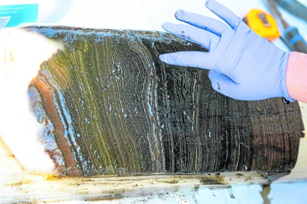 STORIES SET IN STONE Among materials being studied by a team of scientists from Carleton and Brock Universities are distinctly lined sediment deposits collected from the lake. —PHOTO BY AFP