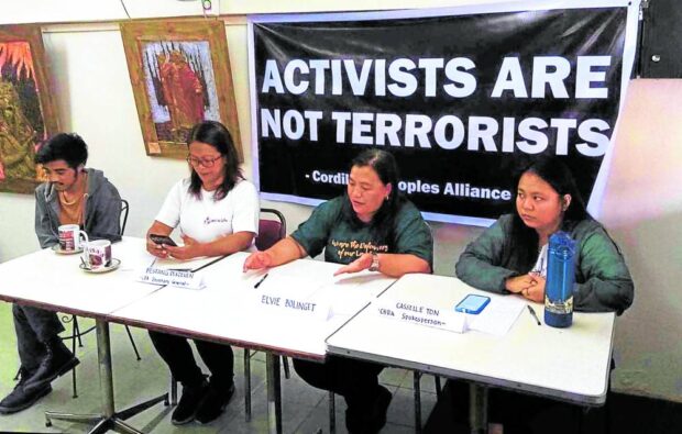 FIGHTING TERROR TAG Elvie Bolinget (third from left) saysher husband, Cordillera Peoples Alliance chair Windel Bolinget, is longtime activist and not a terrorist, contrary to the designation made by Anti Terrorism Council covering him and three other CPA activists. CPA secretary general Sara Dekdeken (second from left) says the government has frozen the group’s assets on July 12. —JETHRO BRYAN ANDRADA