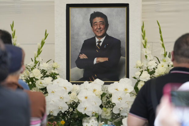People offer prayers for former Prime Minister Shinzo Abe at Zojoji temple in Tokyo, Japan, Saturday, July 8, 2023. Japan marked first anniversary of the death of Abe who was shot while giving an outdoor campaign speech.(AP Photo/Shuji Kajiyama)