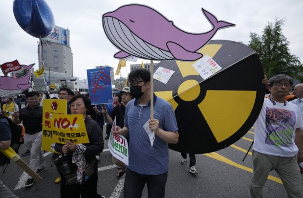 Protesters march toward the Japanese Embassy during rally against the Japanese government's decision to release treated radioactive water from the damaged Fukushima nuclear power plant, in Seoul, South Korea, Saturday, July 8, 2023. (AP Photo/Ahn Young-joon)