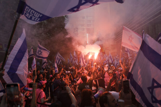Israeli protesters blocked highways and gathered outside Tel Aviv's stock exchange and military headquarters in the latest countrywide demonstration