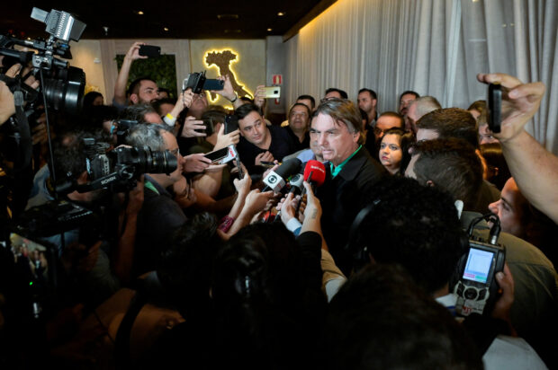 Brazil's former President Jair Bolsonaro talks with media at a restaurant in Belo Horizonte