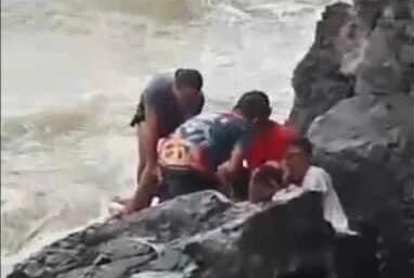 Rescuers try to save a 57-year-old British national who drowned after pulling his son toward a shallow portion of the water at a beach area in Olongapo City on Sunday, July 16. (Photo courtesy of Olongapo City Police Station 6)