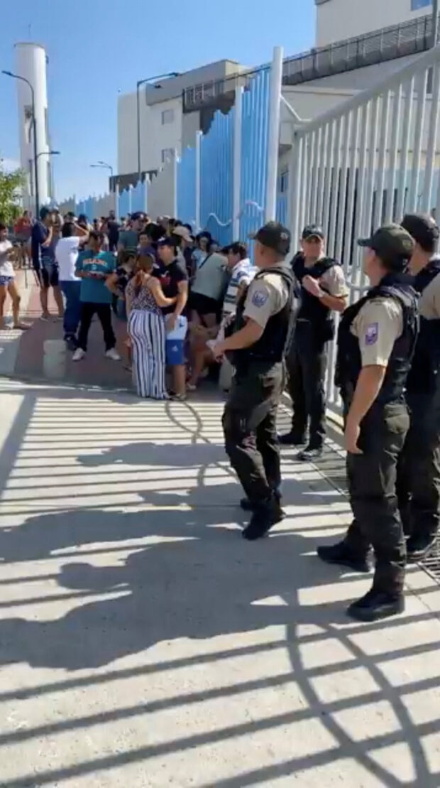 People gather outisde a hospital after the mayor of the Ecuadorian city of Manta was assassinated in attack