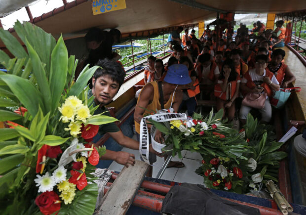 Flowers for the victims are being transported on the boat with passengers going to Talim Island from Binangonan Port in Rizal province. At least 26 passengers were killed after the passenger boat capsized due to strong winds and heavy rain brought Typhoon Egay.INQUIRER PHOTO / RICHARD A. REYES