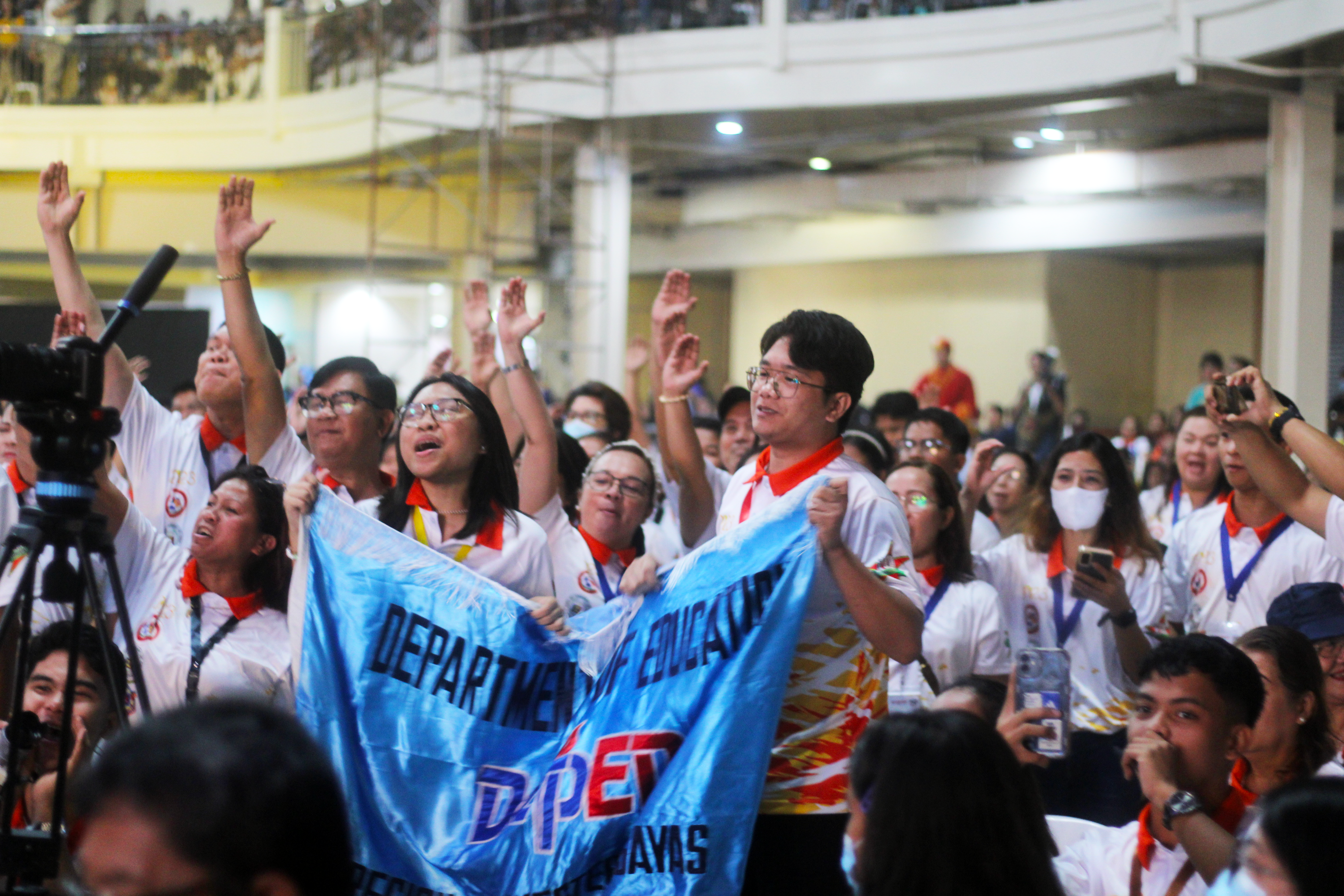 Delegates from Western Visayas cheer for their region during the roll call of participants.