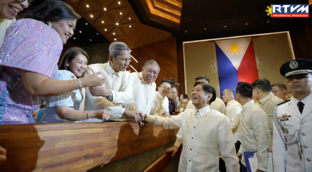 President Ferdinand Marcos Jr. greets guests after he delivers his second State of the Nation Address.