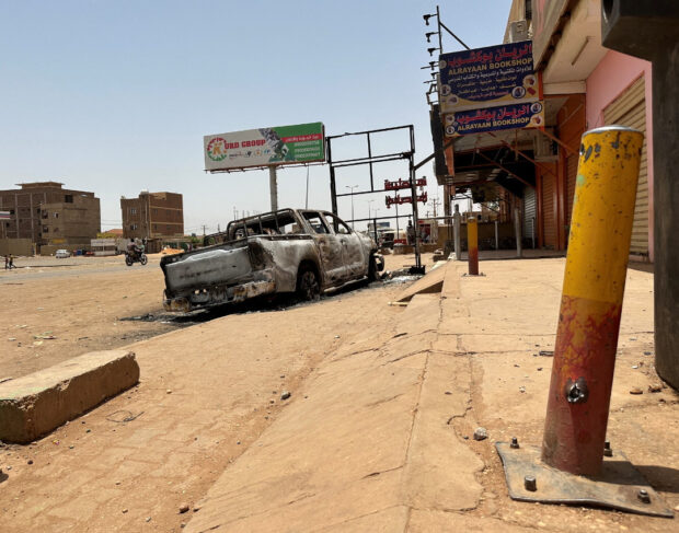 A view shows a destroyed vehicle as clashes between the army and the paramilitary Rapid Support Forces (RSF) continue, in Omdurman