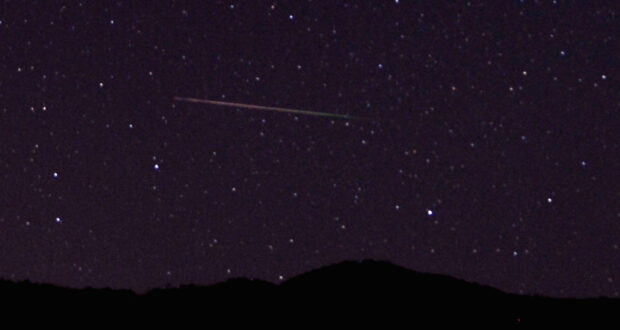 FILE PHOTO: A meteor streaks over the northern skies in the early morning during the Perseid meteor shower north of Castaic Lake, California