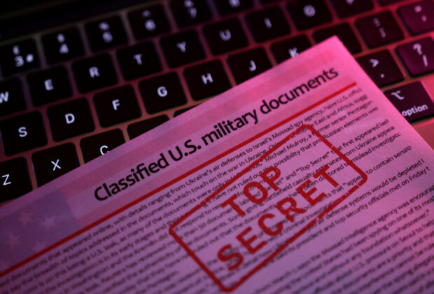 A mockup representation of classified U.S. military documents and a keyboard are seen in this illustration