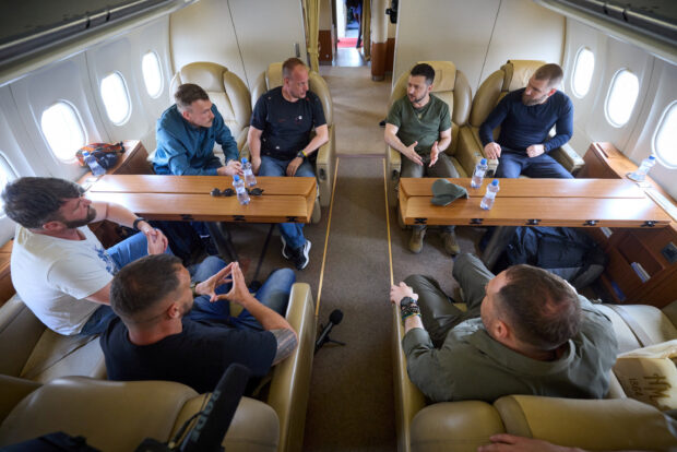 Ukraine's President Volodymyr Zelenskiy speaks with commanders of defenders of the Azovstal Iron and Steel Works in Mariupol Denys Prokopenko, Sviatoslav Palamar, Denys Shleha, Serhii Volynskyi and Oleh Homenko inside a plane as they return to Ukraine from Istanbul, Turkey July 8, 2023. Ukrainian Presidential Press Service/Handout via REUTERS