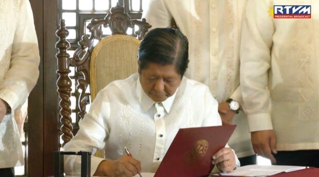 President Ferdinand Marcos Jr. signs the Maharlika Investment Fund bill on Tuesday, July 18, 2023. He also laughs off fears of corruption surrounding Maharlika Investment Fund, says it's ‘Far from the truth’.