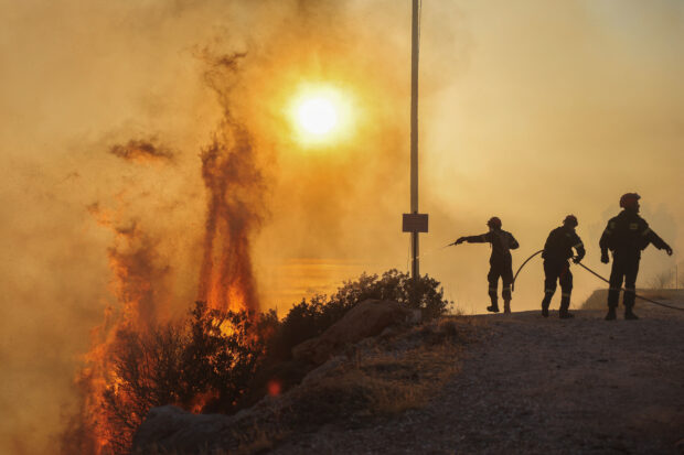 Wildfires burn homes near Greek capital
