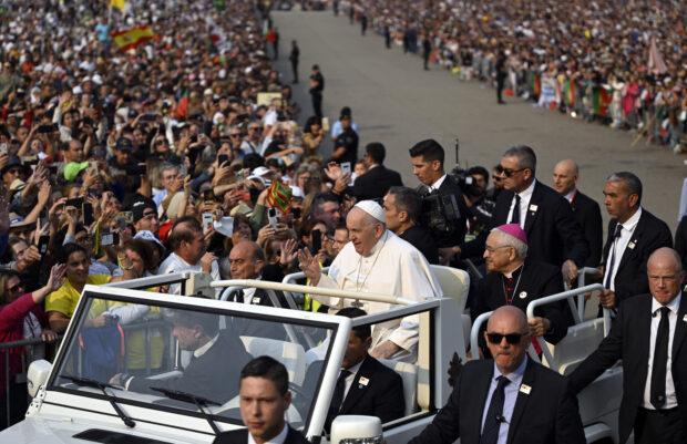 Pope Francis waves from the popemobile prior to presiding over the Holy Rosary prayer with sick young people at the Chapel of Apparitions in the Sanctuary of Our Lady of Fatima, in Fatima, on August 5, 2023. Around one million pilgrims from all over the world will attend the World Youth Day, the largest Catholic gathering in the world, created in 1986 by John Paul II. (Photo by Patricia DE MELO MOREIRA / AFP)
