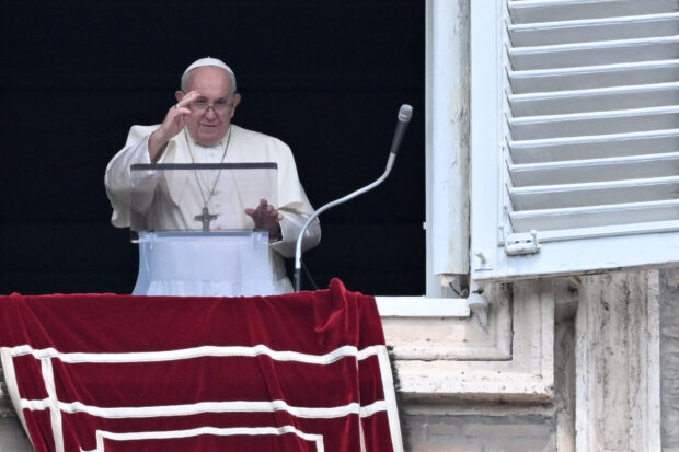 Pope Francis greets the crowd from the window of the apostolic palace overlooking St. Peter's square during the weekly Angelus prayer on August 27, 2023 in The Vatican. (Photo by Tiziana FABI / AFP)