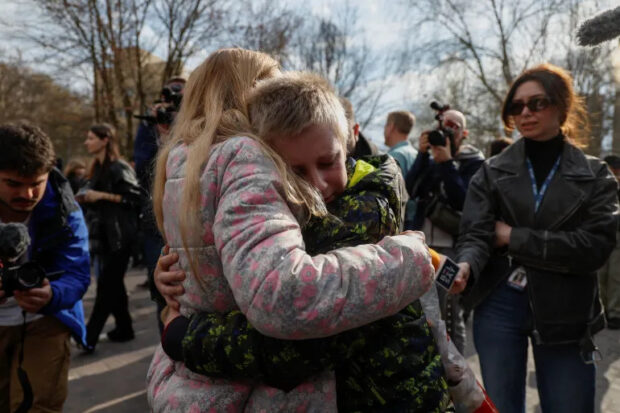 Iryna embraces her 13-year-old son Bohdan, who went to a Russian-organised summer camp from non-government controlled territories and was then taken to Russia, after he returned via the Ukraine-Belarus border, in Kyiv, Ukraine April 8, 2023. REUTERS