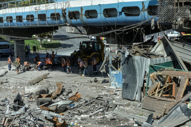 Communal workers clean at the site of a area destroyed during a Russian military strike, amid Russia's attack on Ukraine, in Dnipro, Ukraine August 24, 2023. REUTERS/Mykola Synelnykov