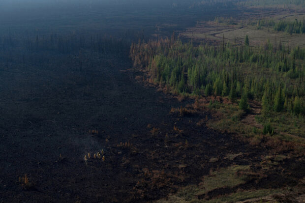 Wildfires in Canada's Northwest Territories force the evacuation of the entire town of Hay River, authorities said.