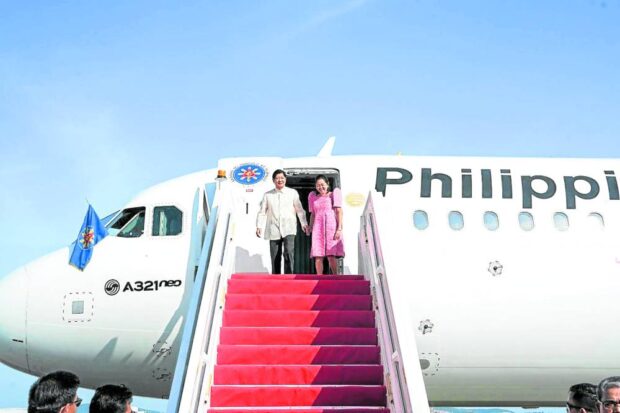 FIFTH STATE VISIT President Marcos leads first lady Liza Araneta-Marcos down the stairs of the presidential plane on arrival in Kuala Lumpur, Malaysia, on July 25. It was the fifth of his state visits since he took office on June 30 last year. —MALACAÑANG PHOTO