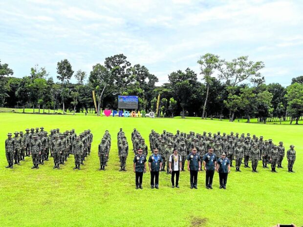 HISTORIC The integration of 102 former Moro rebels into the Philippine National Police, as mandated by a peace deal with the government, has been described as historic for the Bangsamoro region. The police recruits are shown here with Interior Secretary Benhur Abalos and other police officials during their oath-taking rites at Camp SK Pendatun in Parang, Maguindanao del Norte, on Aug. 10. —PRO-Barmm