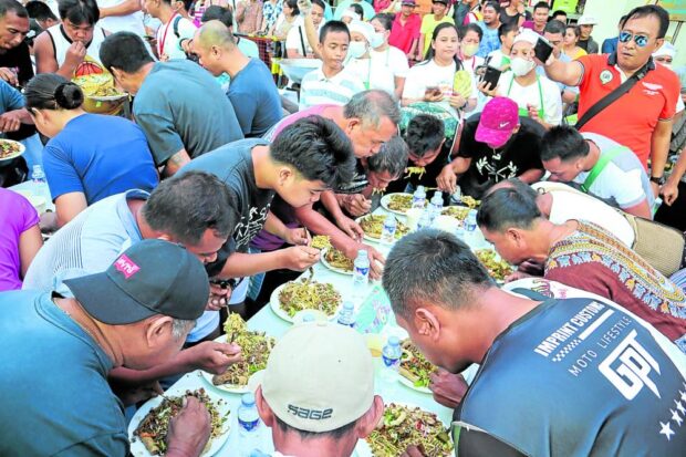 Residents feast on rice noodles during the Pansi Batil Fotun Festival in Tuguegarao City on Saturday, Aug. 12, 2023,
