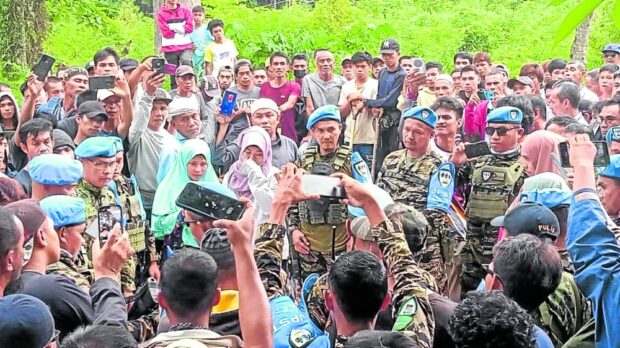 A SAD DAY Military and police members of the Joint Peace and Security Team in Basilan condole with the family and relatives of Police Cpl. Abdurafiq Gafor Akalun. —PHOTO CONTRIBUTED BY JPST BASILAN