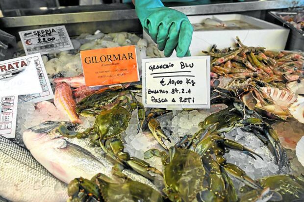 Blue crabs are sold at a local shop in Cortellazzo near Venice, Italy, on Aug. 11, 2023. The blue crab, an aggressive species native to the North American Atlantic coast, has increasingly threatened local shellfish and fish in the delta where the River Po reaches the Adriatic Sea.