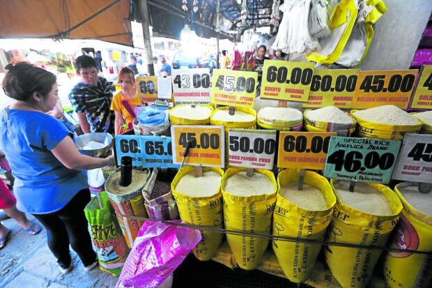 Prices of assorted varieties of rice are displayed at Trabajo Market in Sampaloc, Manila, in this photo taken on Aug. 10, 2023, to guide consumers on a tight budget.