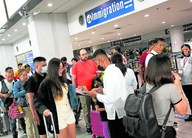 DOCUMENT CHECK International passengers queue to have their travel documents checked at Ninoy Aquino International Airport Terminal 3 in Pasay City in this photo taken in July. —RICHARD A. REYES 