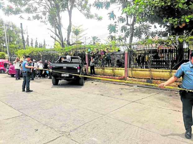 Police cordon off a roadside at the town plaza of Midsayap, Cotabato, following the shooting on Aug. 29, 2023, of an aspiring village chief in the Bangsamoro region.