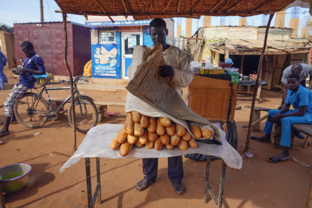 A man sells baguettes in Niamey, Niger, Friday, Aug. 11, 2023.
