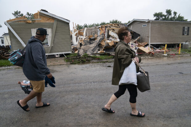 Sean Johnson walks with his girlfriend Angela Taylor to check out thier Frenchtown Villas Monroe home in Newport, Mich., on Friday, Aug. 25, 2023, after a heavy band of storms hit the region on Thursday. 