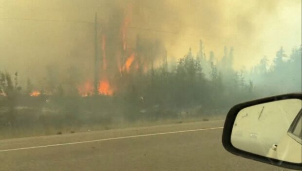 This screengrab from a video provided by Jordan Straker shows vehicles driving on the freeway as people evacuate from Yellowkife, Northwest Territories, Canada, on August 16, 2023. Thousands ordered to flee wildfires advancing on one of the largest cities in Canada's far north crammed into a local airport on August 17, 2023, to board emergency evacuation flights, as convoys snaked south to safety on the only open highway. The order late on August 16, 2023, to evacuate Yellowknife in the Northwest Territories marked the latest chapter of a terrible summer for wildfires in Canada, with tens of thousands of people forced to leave their homes and vast swathes of land scorched. (Photo by Jordan Straker / UGC / AFP) / RESTRICTED TO EDITORIAL USE – MANDATORY CREDIT « AFP PHOTO / Jordan Straker » - NO MARKETING NO ADVERTISING CAMPAIGNS – DISTRIBUTED AS A SERVICE TO CLIENTS [ NO ARCHIVE ]