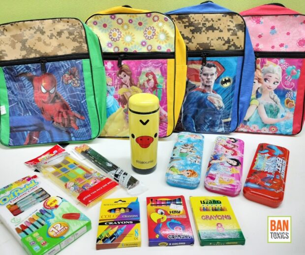 School supplies: knapsacks, a water thermos, pencil cases, and boxes of crayons